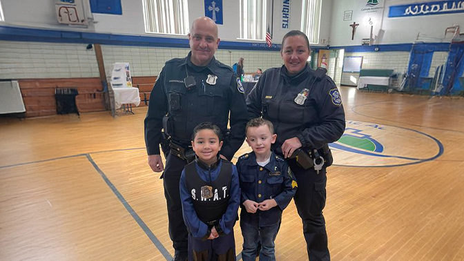 Officers with kids in gymnasium