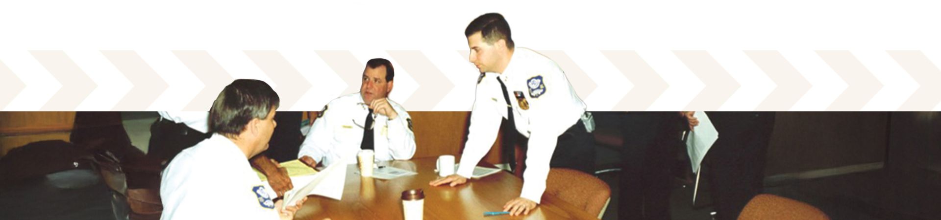 Police officers at table talking to each other