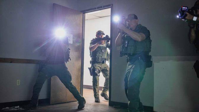Three Waterbury police special operations officers entering a room during training