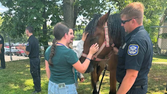 Waterbury police officer with a horse at an outdoor community event